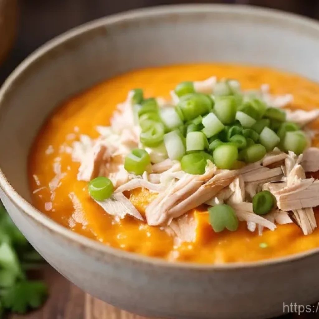 고구마와 채소로 만든 한 그릇식사 - A close-up shot of a steaming, creamy sweet potato and shredded chicken porridge in a warm, rustic c...